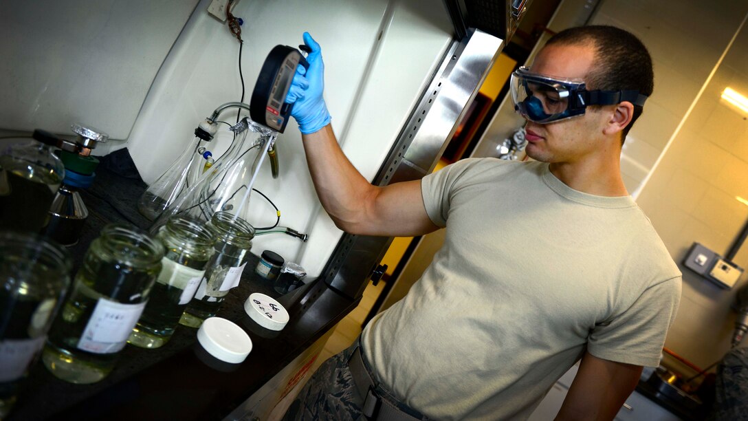 U.S. Air Force Senior Airman Devin Brown-Redfearn, 31st Logistics Readiness Squadron petroleum oils and lubricants lab technician, uses an automated density reader to determine the temperature and density of fuel, Aug. 25, 2015, at Aviano Air Base, Italy. The fuels laboratory ensures fuel quality by running it through a series of tests, including checking for water, which can cause aircraft engine malfunctions at high altitudes. (U.S. Air Force photo by Senior Airman Areca T. Wilson/Released)