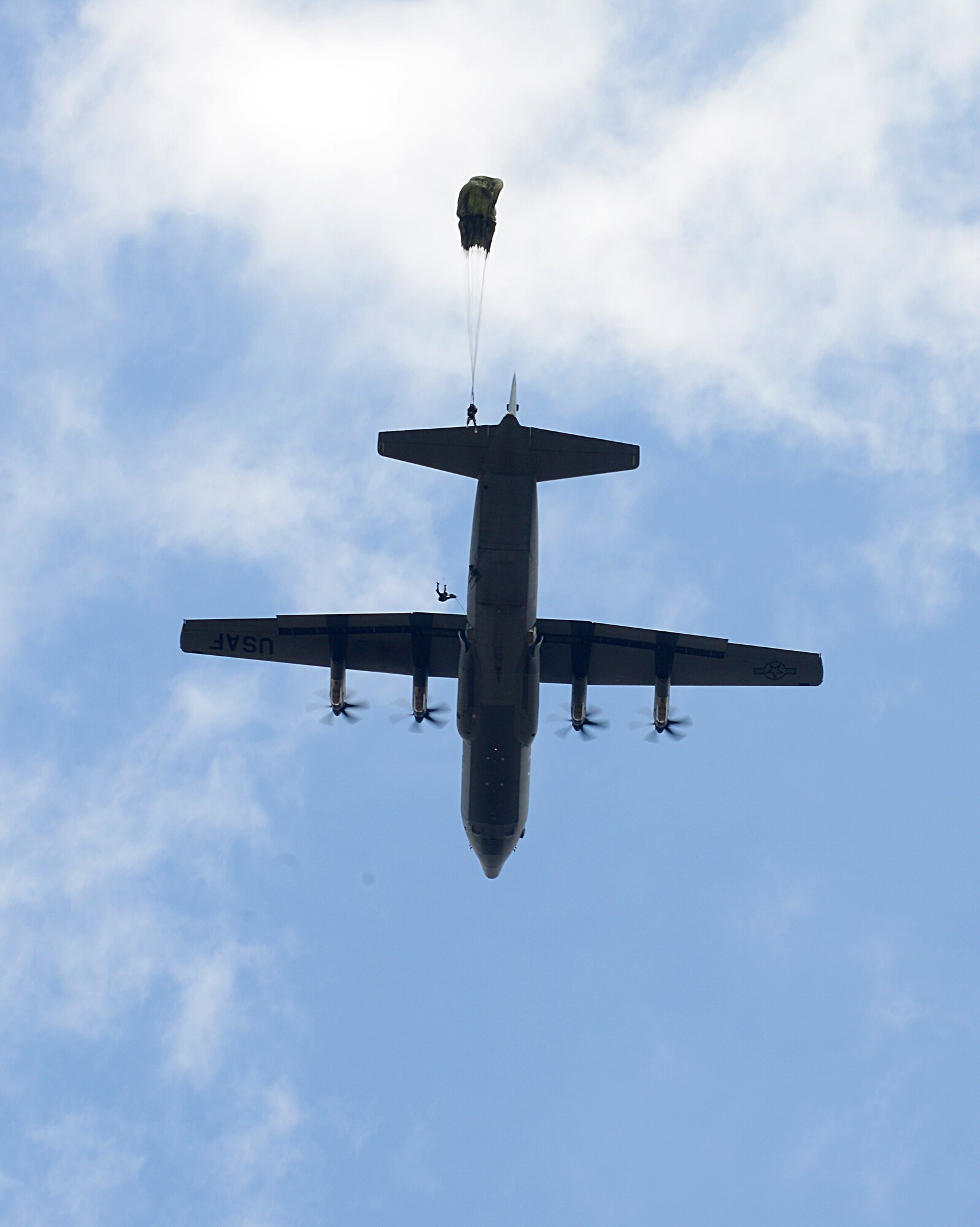 Romanian paratroopers jump from a U.S. Air Force C-130J Super Hercules during a static line airborne operation Aug. 18, 2015, over Boboc Air Base, Romania. Three C-130Js assigned to the 37th Airlift Squadron participated in the first week of the two-week long exercise Carpathian Summer. (U.S. Air Force photo/Senior Airman Timothy Moore)