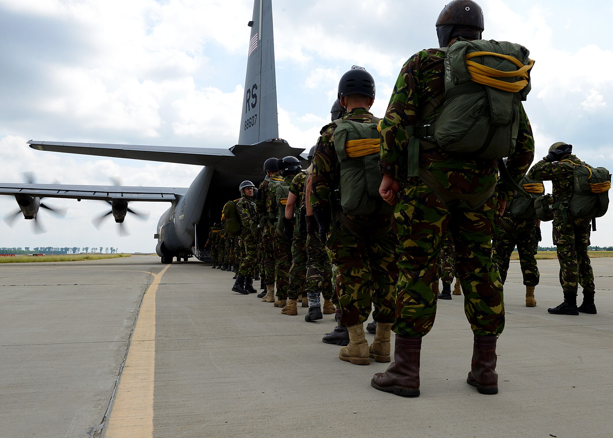Romanian paratroopers wait to board a U.S. Air Force C-130J Super Hercules Aug. 18, 2015, at Boboc Air Base, Romania. Romanian paratroopers practiced both freefall and static line airborne operations as part of exercise Carpathian Summer, a bilateral training event designed to increase readiness and interoperability between the U.S. Air Force and Romanian air force. (U.S. Air Force photo/Senior Airman Timothy Moore)