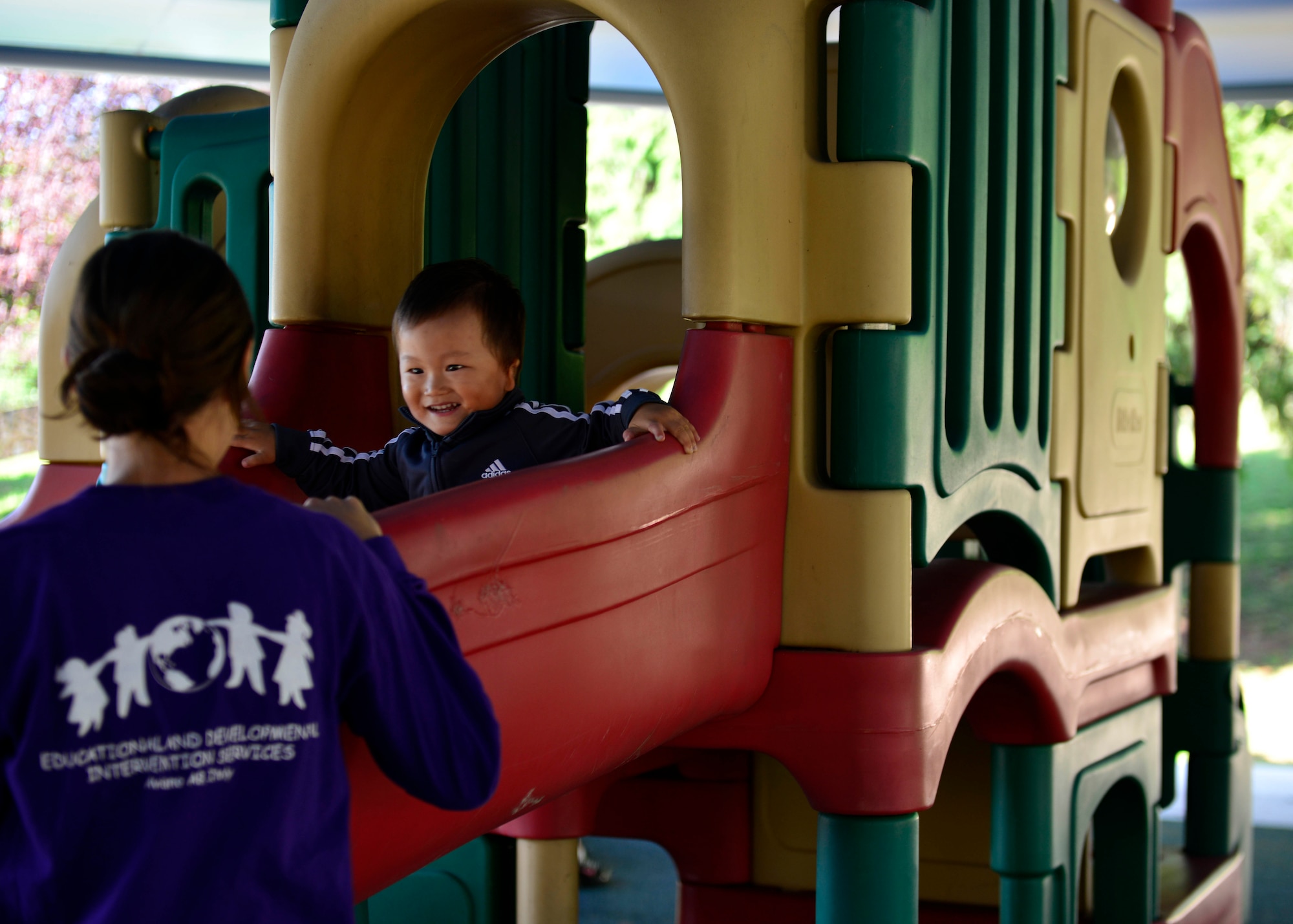 Megan Trifilo watches her son, Griffin, play during Educational and Developmental Intervention Services outdoor playtime, Aug. 17, 2015, at Aviano Air Base, Italy. The playground was specifically designed for all children under the ages of three, providing both parents and their children a chance to interact. (U.S. Air Force photo by Airman 1st Class Cary Smith/Released)