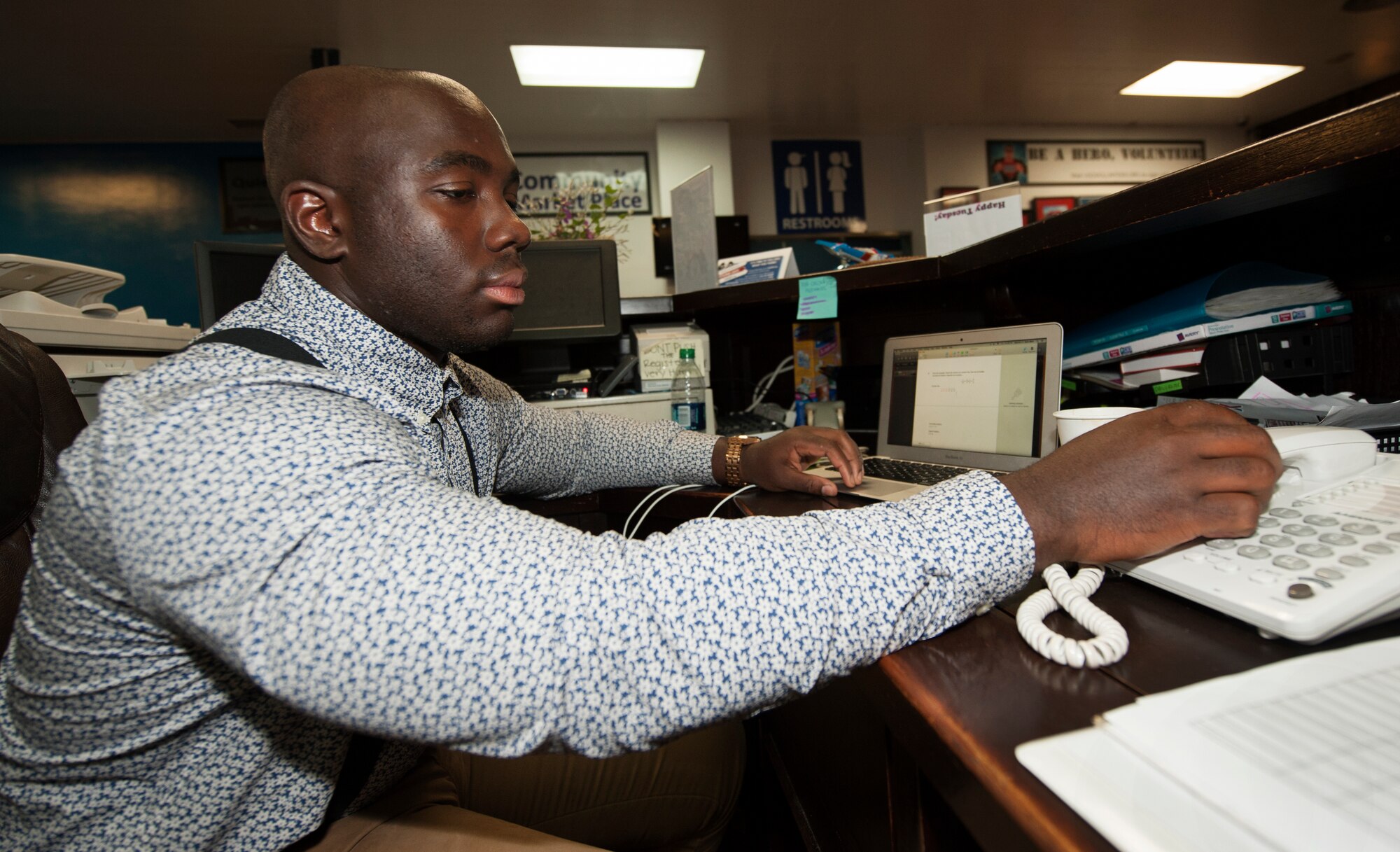 U.S. Air Force Airman 1st Class Ashmiru Sallu-sam, 18th Civil Engineer squadron water and fuels systems apprentice, answers the Airmen Against Drunk Driving on-call phone at Kadena Air Base, Japan, Aug. 21, 2015. The AADD program saves an average of 40 lives and careers each weekend. (U.S. Air Force photo by Airman 1st Class Zackary A. Henry)