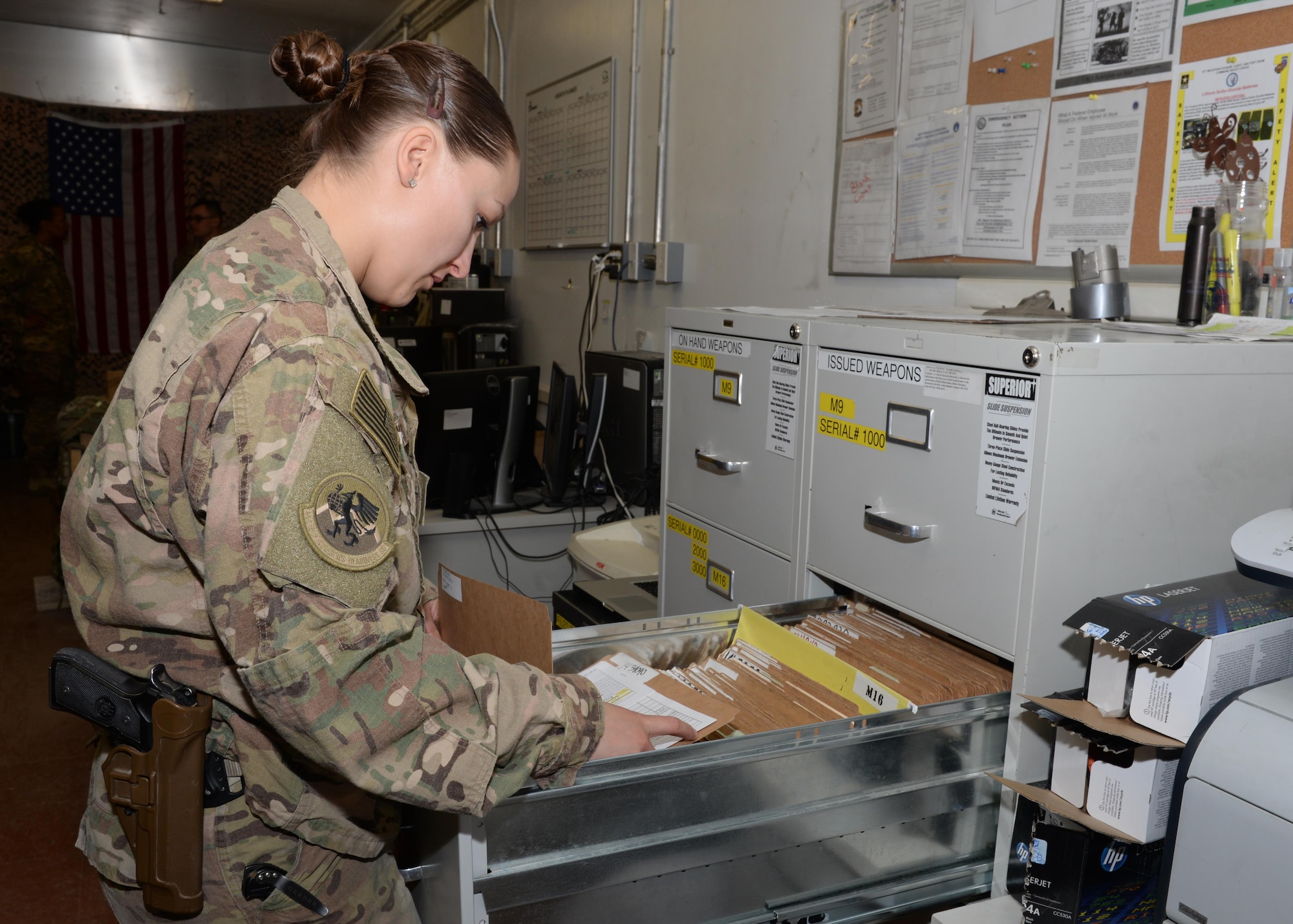 U.S. Air Force Staff Sgt. Brenda Hawkins, 455th Expeditionary Logistics Readiness Squadron non-commissioned officer in charge of the armory, files a receipt after issuing a weapon to an Airman Aug. 26, 2015, at Bagram Airfield, Afghanistan. Hawkins is responsible for issuing weapons to Airmen of the 455th AEW that do not deploy with but require a weapon during their deployment. (U.S. Air Force photo by Senior Airman Cierra Presentado/Released)