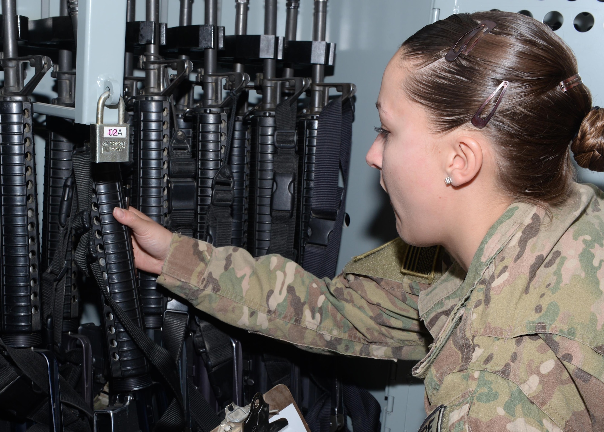U.S. Air Force Staff Sgt. Brenda Hawkins, 455th Expeditionary Logistics Readiness Squadron non-commissioned officer in charge of the armory, goes through the weapons storage for accountability Aug. 26, 2015, at Bagram Airfield, Afghanistan. Hawkins is responsible for issuing weapons to Airmen of the 455th AEW that do not deploy with but require a weapon during their deployment. (U.S. Air Force photo by Senior Airman Cierra Presentado/Released)