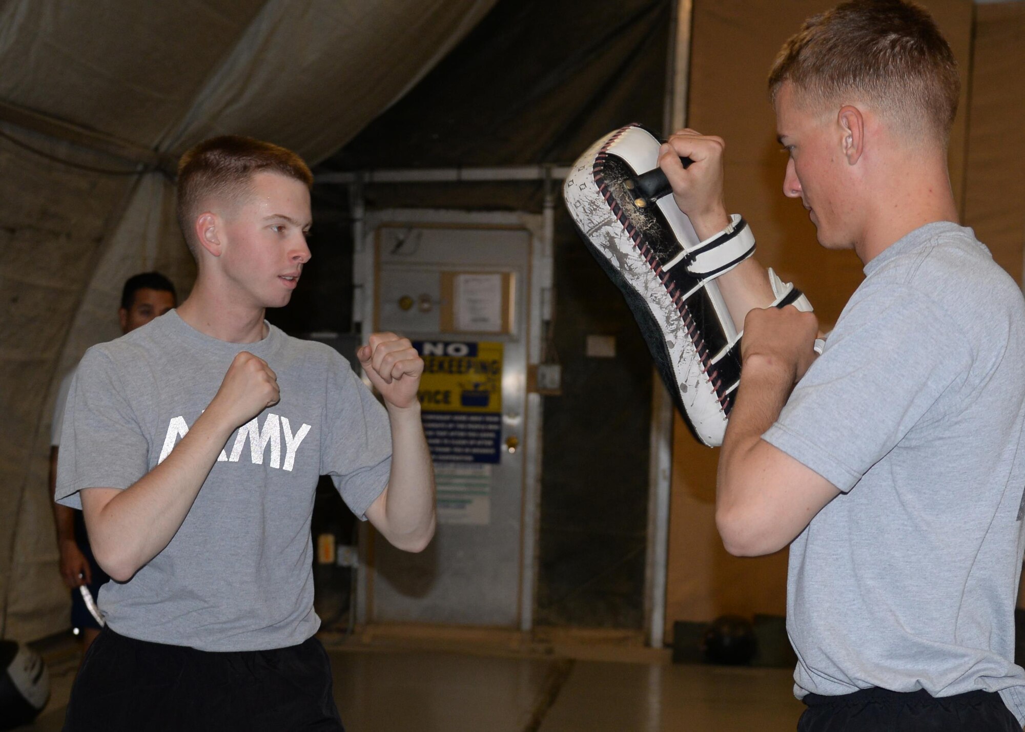 U.S. Army Spc. Cody Hougnon throws a punch at Spc. Cameron Hicks, Task Force Solid personal security detachment team members, during a combatives class Aug. 25, 2015, at Bagram Airfield, Afghanistan. The combatives class is offered to military members on Bagram who are interested in learning self-defense while in the AOR. (U.S. Air Force photo by Senior Airman Cierra Presentado/Released)