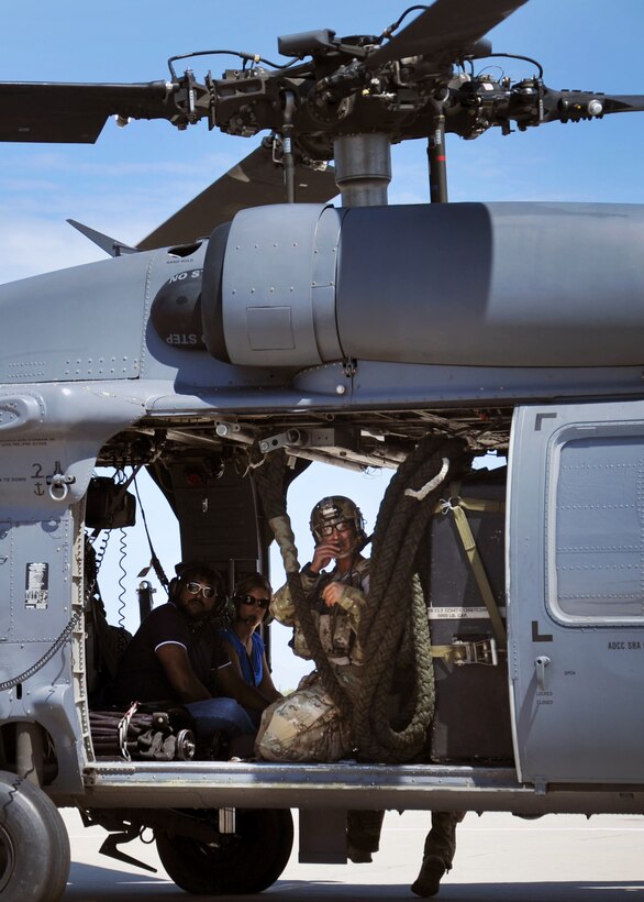 U.S. Air Force Reserve 2nd Lt. Ryan Gilbert, right, a 306th Rescue Squadron combat rescue officer, prepares for flight in an HH-60 Pavehawk with congressional staff delegation members Aug. 26. He was part of the search and recovery effort for Jerald Joseph Williams, who went missing in the Kaibab National Forest north of the Grand Canyon Aug. 6. (U.S. Air Force photo/Staff Sgt. Carolyn Herrick)