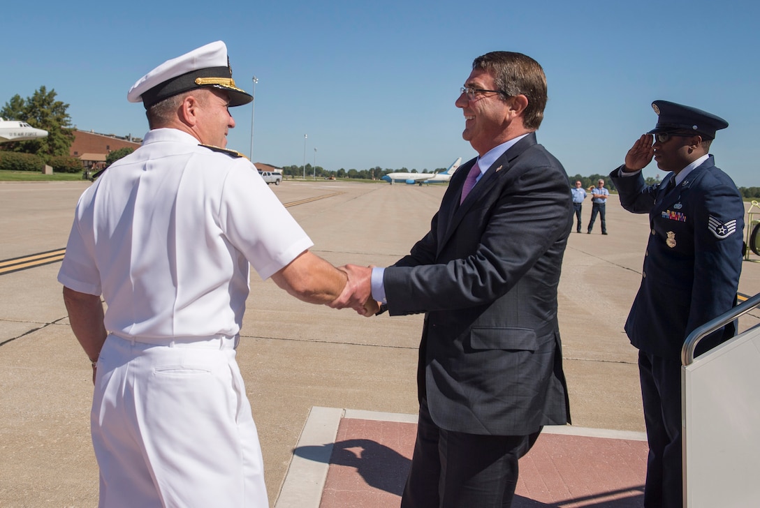 Defense Secretary Ash Carter, right, exchanges greetings with Navy Vice Adm. William Brown, deputy commander of U.S. Transportation Command, upon arriving on Scott Air Force Base, Ill., Aug. 26, 2015, for an assumption-of-command ceremony. Carter delivered remarks at the ceremony, during which Air Force Gen. Darren W. McDew assumed leadership of U.S. Transportation Command. DoD photo by U.S. Air Force Master Sgt. Adrian Cadiz