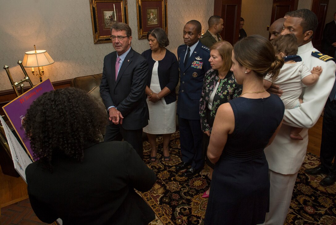 Defense Secretary Ash Carter and Air Force Gen. Darren W. McDew receive a briefing on the order of events for the U.S. Transportation Command assumption-of-command ceremony on Scott Air Force Base, Ill., Aug. 26, 2015. McDew assumed leadership of the command during the ceremony. DoD photo by U.S. Air Force Master Sgt. Adrian Cadiz