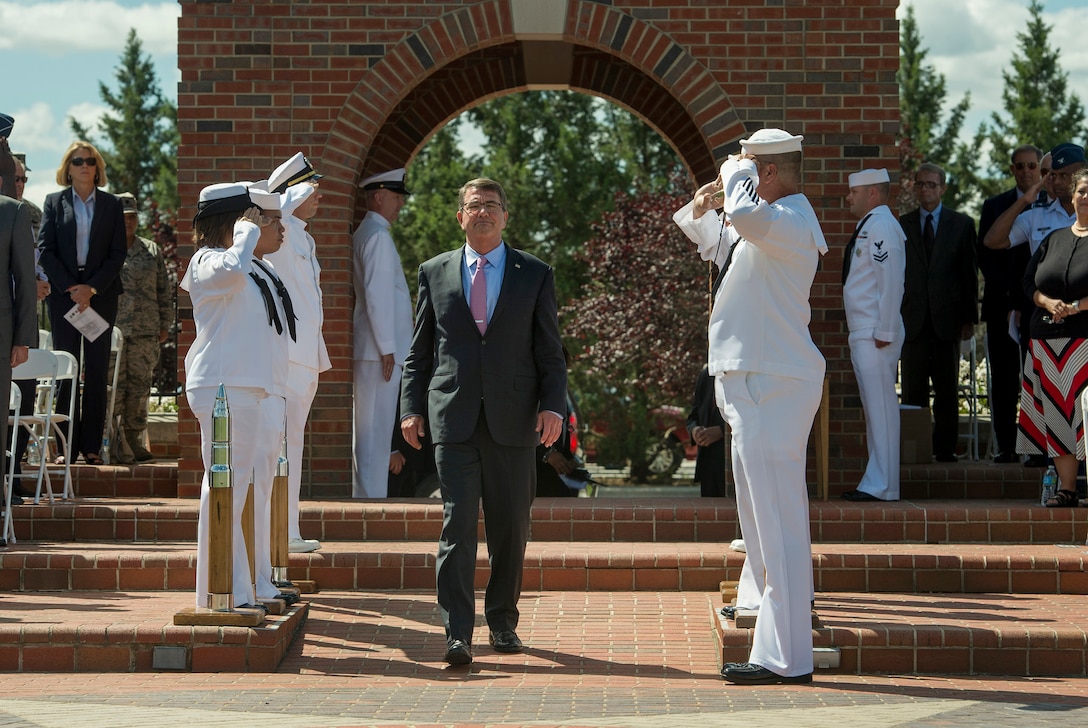 Service members salute as Defense Secretary Ash Carter walks onto the parade field during an assumption-of-command ceremony on Scott Air Force Base, Ill., Aug. 26, 2015. Air Force Gen. Darren W. McDew assumed leadership of U.S. Transportation Command during the ceremony. DoD photo by U.S. Air Force Master Sgt. Adrian Cadiz