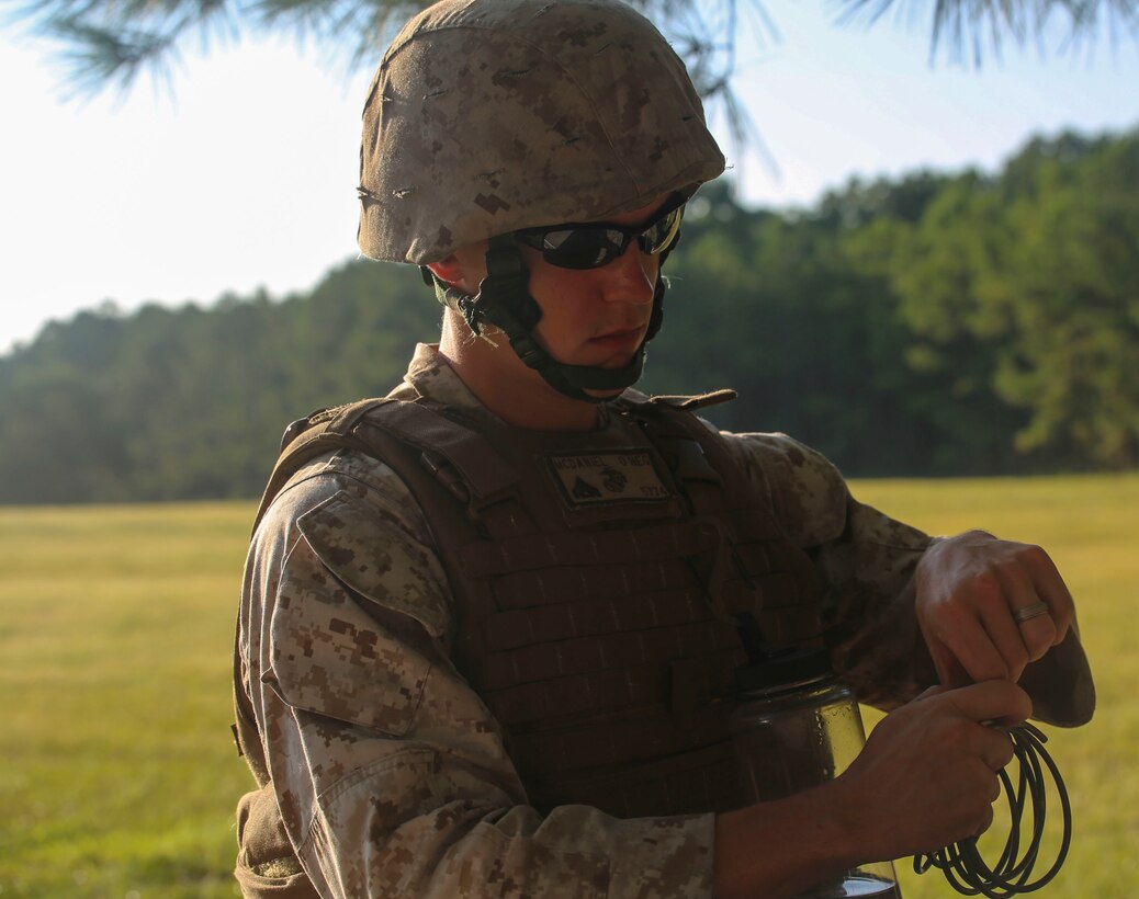 A Marine with Engineer Company, Marine Wing Support Squadron 272, measures a timing fuse during a demolition range exercise aboard Camp Lejeune, N.C., Aug. 21, 2015. Demolition skills are essential to any combat engineer unit and allow Marines with MWSS-272 the ability to clear space for aviation operations in a variety of terrain around the globe. (U.S. Marine Corps photo by Lance Cpl. Fatmeh Saad/Released)