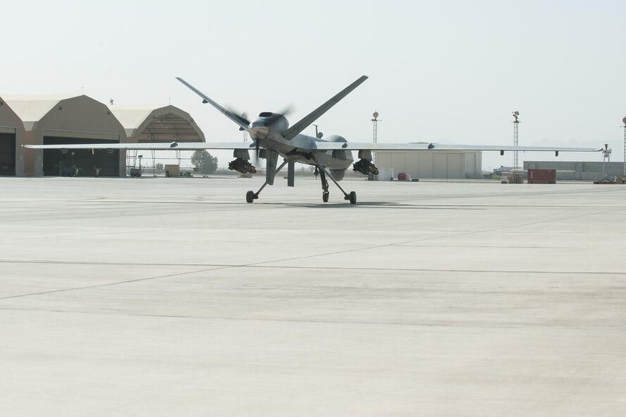 A U.S. Air Force MQ-9 Reaper taxis after receiving maintenance from Senior Airman Sarah Morales, 62nd Expeditionary Reconnaissance Squadron Reaper aircraft technician, at Kandahar Airfield, Aug. 14, 2015. Morales keeps the Reapers at KAF in the air by performing routine maintenance on the aircraft as well as launching and recovering them to keep the missions and sorties going. (U.S. Air Force photo by Tech. Sgt. Joseph Swafford/Released)