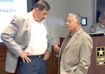 Retired Maj. Gen. Simeon G. Trombitas (left), U.S. Army South commanding general from November 2009 to September 2012, speaks with retired Maj. Gen. Alfred A. Valenzuela, ARSOUTH CG from July 2000 to October 2003, during a break in the former commanders’ conference at the command’s headquarters on Fort Sam Houston Aug. 10.