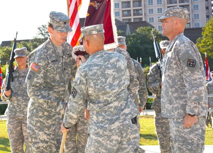 Far right) Outgoing commander Col. Jerrod Killian watches as 32nd Medical Brigade commander Col. Jack Davis (center) presents the 264th Medical Battalion colors to incoming commander Lt. Col. Werner Barden at the U.S. Army Medical Department Museum courtyard at Fort Sam Houston Aug 4.