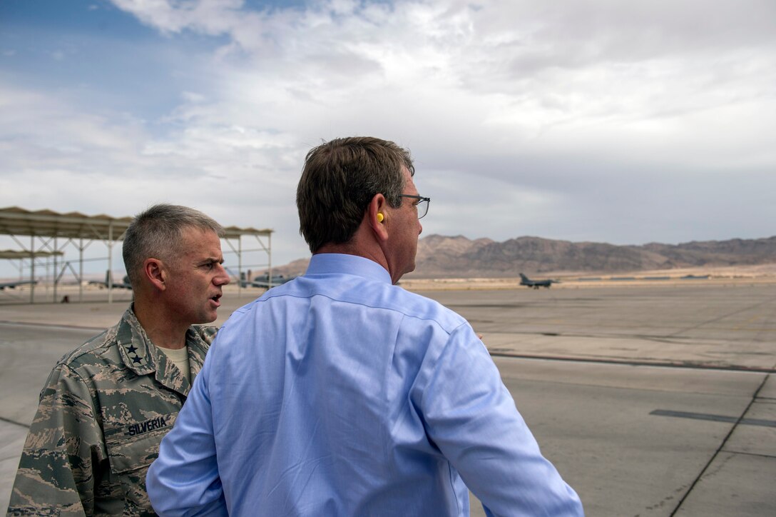Maj. Gen. Jay B. Silveria, commander of the U.S. Air Force Warfare Center, speaks with Defense Secretary Ash Carter as they watch aircraft launch as part of a Red Flag Exercise on Nellis Air Force Base, Nev., Aug. 26, 2015. DoD photo by U.S. Air Force Master Sgt. Adrian Cadiz