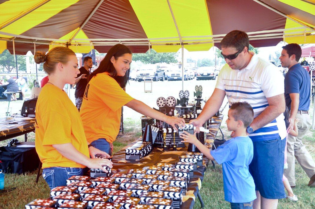 Pfc. Megan Schriever and Sgt. Jessica Martin from Manpower Reserves Management and Process office hand out gifts to the children of government employees during the Civilian Appreciation Annual Picnic at Barnett Field aboard Marine Corps Base Quantico, Aug 20. Attendees of all ages enjoyed activities that included movie trivia, dancing and picnic lunch catered by Mission BBQ. 