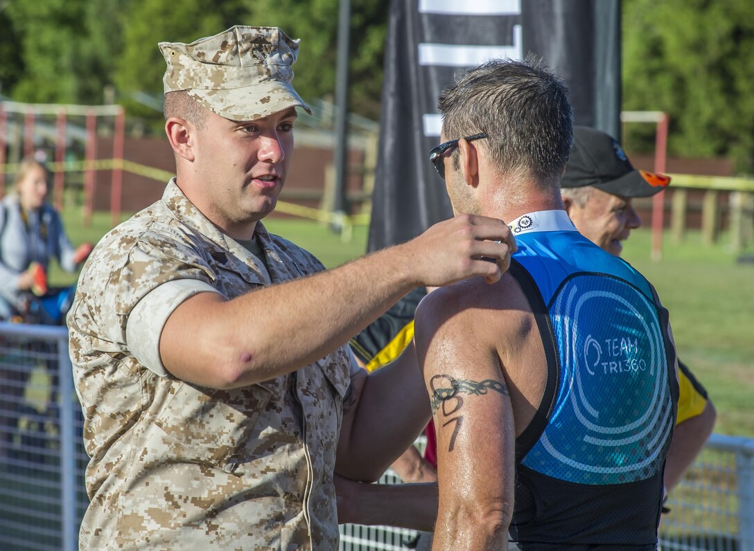 Triatheletes compete in the Quantico Triathlon hosted by Marine Corps Marathon's, Quantico, Va., Aug. 22, 2015. The Triathlon is a three part event consisting of a 750 meter open water swim, 20K cycle tour, and 5K run to complete the entire race. (U.S. Marine Corps photo by Lance Cpl. Elisha N. Peake/Not Released)
