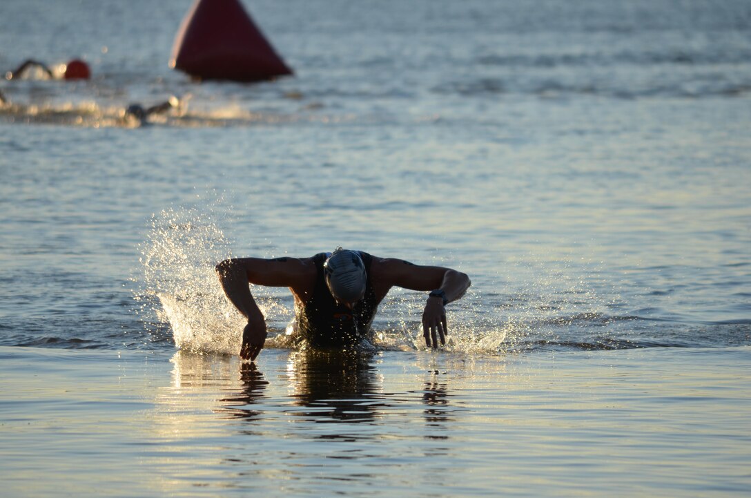 David Henkel of Fairfax, Va. finishes the swim portion of Saturday’s Quantico Triathlon with a powerful butterfly stroke, enabling him to finish the swim first and take second place overall for the race.