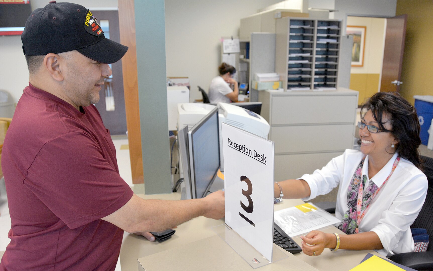 Maria Colbert checks in retired Sgt. 1st Class Raul Fuentez for his appointment Aug. 18 at the new Westover Medical Home.