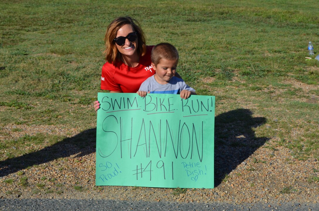 During the second annual Quantico Triathlon, held Saturday, Crystal Herbison and her son Landon, 4, root for their friend Shannon Petitjean, who was participating in her first triathlon.