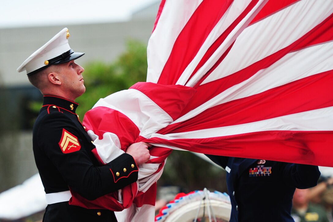 An United States Marine takes the American flag into his hands before folding it with the flag detail at the POW/MIA rememberance day retreat ceremony on September 16, 2011, Joint Base Charleston, S.C.  Joint Base Charleston honored POW/MIA rememberance day with a 24-hour run that ended at the retreat ceremony followed by a wreath laying and a fly-over.  Former POW's as well as members of Joint Base Charleston were in attendance.    (U.S. Air Force photo/ Staff Sgt. Nicole Mickle) (RELEASED)  