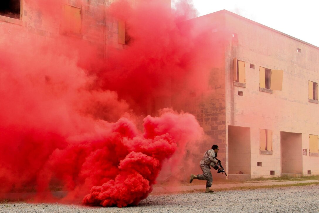 Soldiers conduct a raid at an urban terrain training site on Fort Pickett, Va., Aug. 20, 2015. The Virginia National Guard launched the two-week exercise to teach infantry skills to noncombat military occupational specialties. Virginia National Guard photo by Army Sgt. Sean Brady