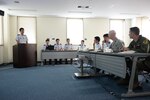 KADENA AIR BASE, Japan (Aug. 26, 2015) - United States Air Force Maj. Christopher L. Teke, 18th Civil Engineer Squadron officer, and Maj. Mark Carl, 909th Air Refueling Squadron assistant director of operations, listen to Airmen from Japan Air Self Defense Force (JASDF) give briefings in English during a completion at Naha Air Base. JASDF hosted an English briefing contest to be judged by American Airmen. 