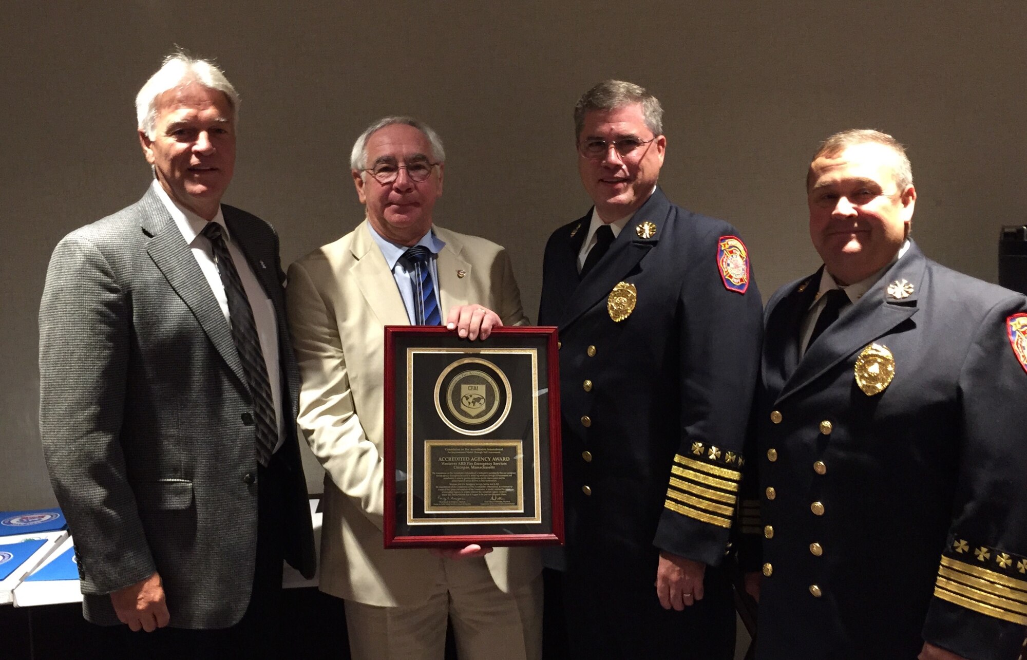 Jim Podolske, the Air Force Fire Chief, from Tyndall Air Force Base, Fla., far left, and Steven Westermann, Chief Fire Officer and CFAI Commission Chair, left, recognize Westover's Fire Chief, Charles Van Gorden and Deputy Chief, Edwin Driscoll. Westover Fire Emergency Services is one of few Air Force fire agencies to receive this accreditation.