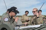 JOINT BASE ELMENDORF-RICHARDSON, Alaska (Aug. 24, 2015) - Flight Lieutenant Phongsakron Namjit, Royal Thai Air Force combat controller, and U.S. Air Force Capt. Michael Spanogle, 3rd Air Support Operations Squadron Air Mobility Liaison Officer, coordinate an airdrop during Red Flag Alaska 15-3. 