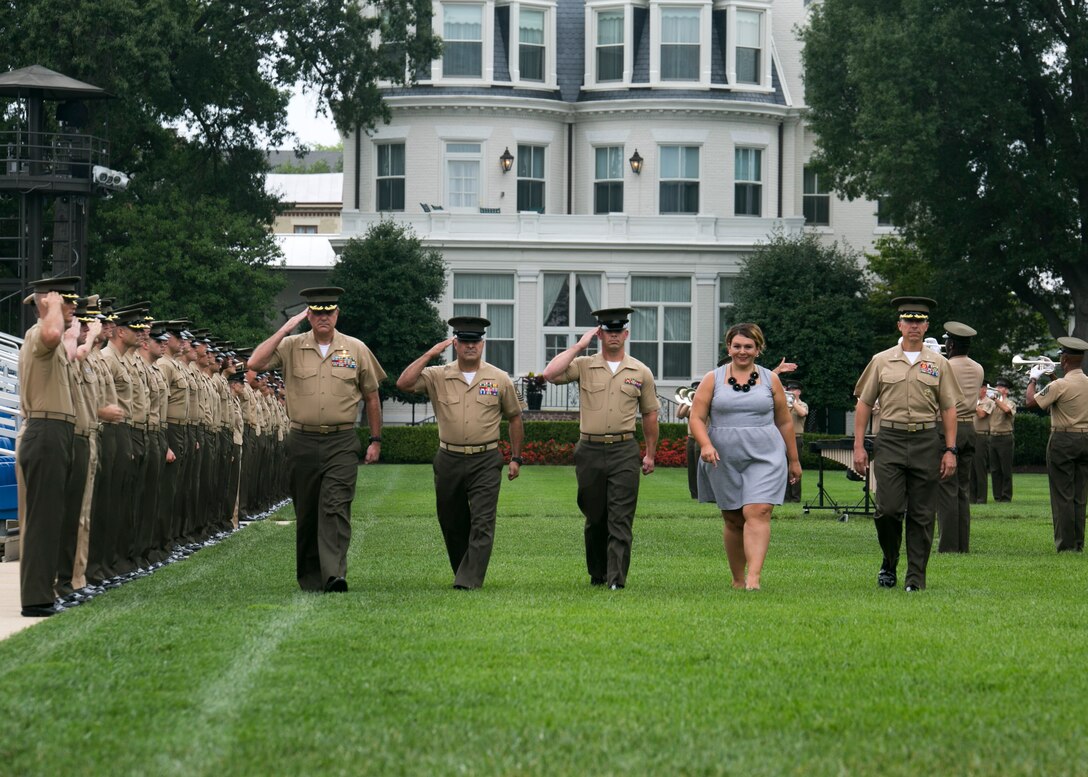Outgoing staff non-commissioned and commissioned officers are bid farewell during a "play-off" at Marine Barracks Washington, D.C., Aug. 20, 2015. The "play-off" is a tradition at the barracks that begins with three songs performed by the U.S. Marine Drum and Bugle Corps. Staff NCOs and officers line the parade deck and salute as the outgoing staff NCOs and officers walk past. (U.S. Marine Corps photo by Cpl. Christian Varney/Released)