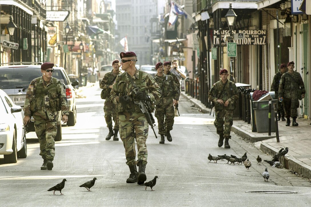 Soldiers patrol nearly deserted streets in the French Quarter in New Orleans, Sept. 13, 2005, as part of U.S. military assistance following Hurricane Katrina. The soldiers are paratroopers assigned to the 82nd Airborne Division's Company B, 2nd Battalion, 505th Parachute Infantry Regiment. DoD photo by Daren Reehl