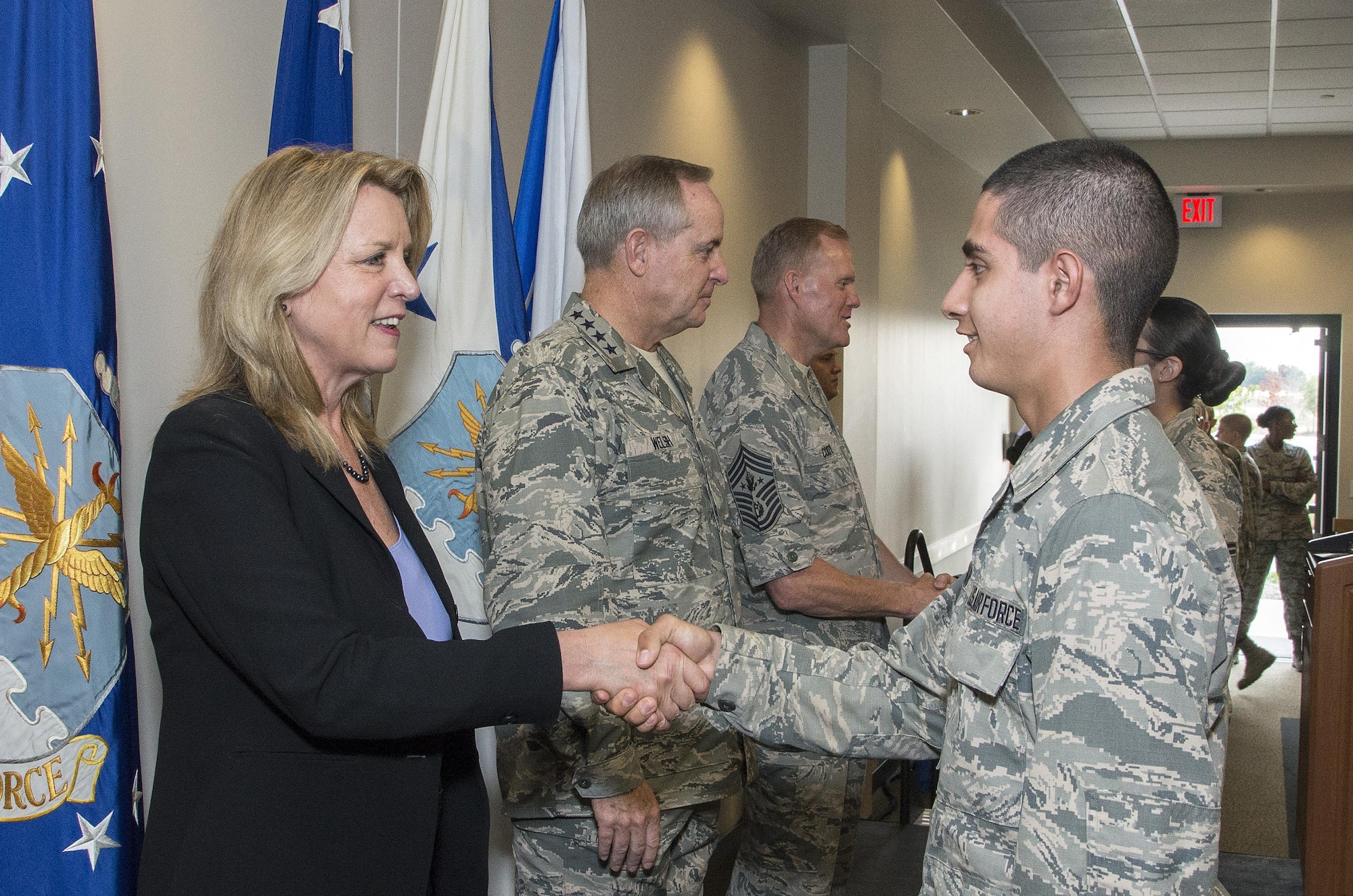Secretary of the Air Force Deborah Lee James, Air Force Chief of Staff General Mark A. Welsh III and Chief Master Sergeant of the Air Force James A. Cody congratulate Airmen who will soon complete Airmen’s Week Aug. 27, 2015, at Joint Base San Antonio-Lackland’s Pfingston Reception Center. The Airmen received a copy of "America's Air Force: A Profession of Arms," the next evolution of the "Little Blue Book" previously released in 1997. The new book gives Airmen instant access to the core values, codes and creeds that guide Airmen as they serve in the Profession of Arms. The book will be distributed to all new Airmen before transitioning to technical training and available online through Air Force e-publishing.