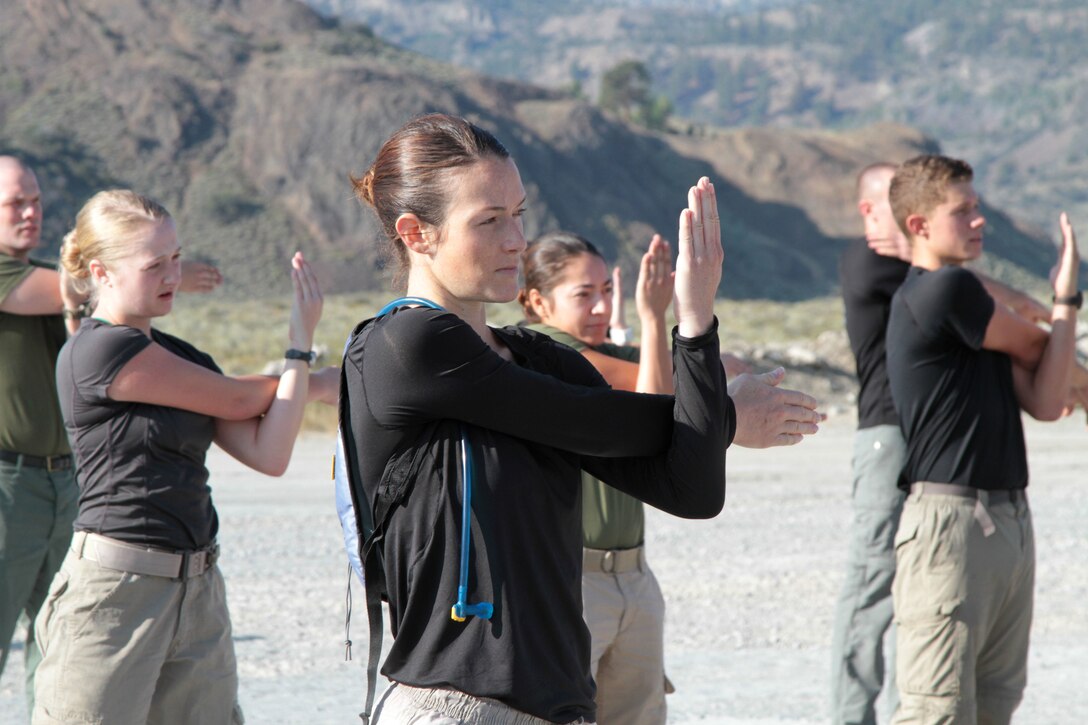 Kate Casey, a 27-year-old native of Lodi, Calif., stretches during physical training at Marine Corps Mountain Warfare Training Center here, Aug. 22, 2015. Casey trained with other officer candidates from Recruiting Station Sacramento as part of “Warrior Weekend.” The candidates hiked steep trails, competed in team exercises, and received classes as part of preparation for Officer Candidate School in Quantico, Va.