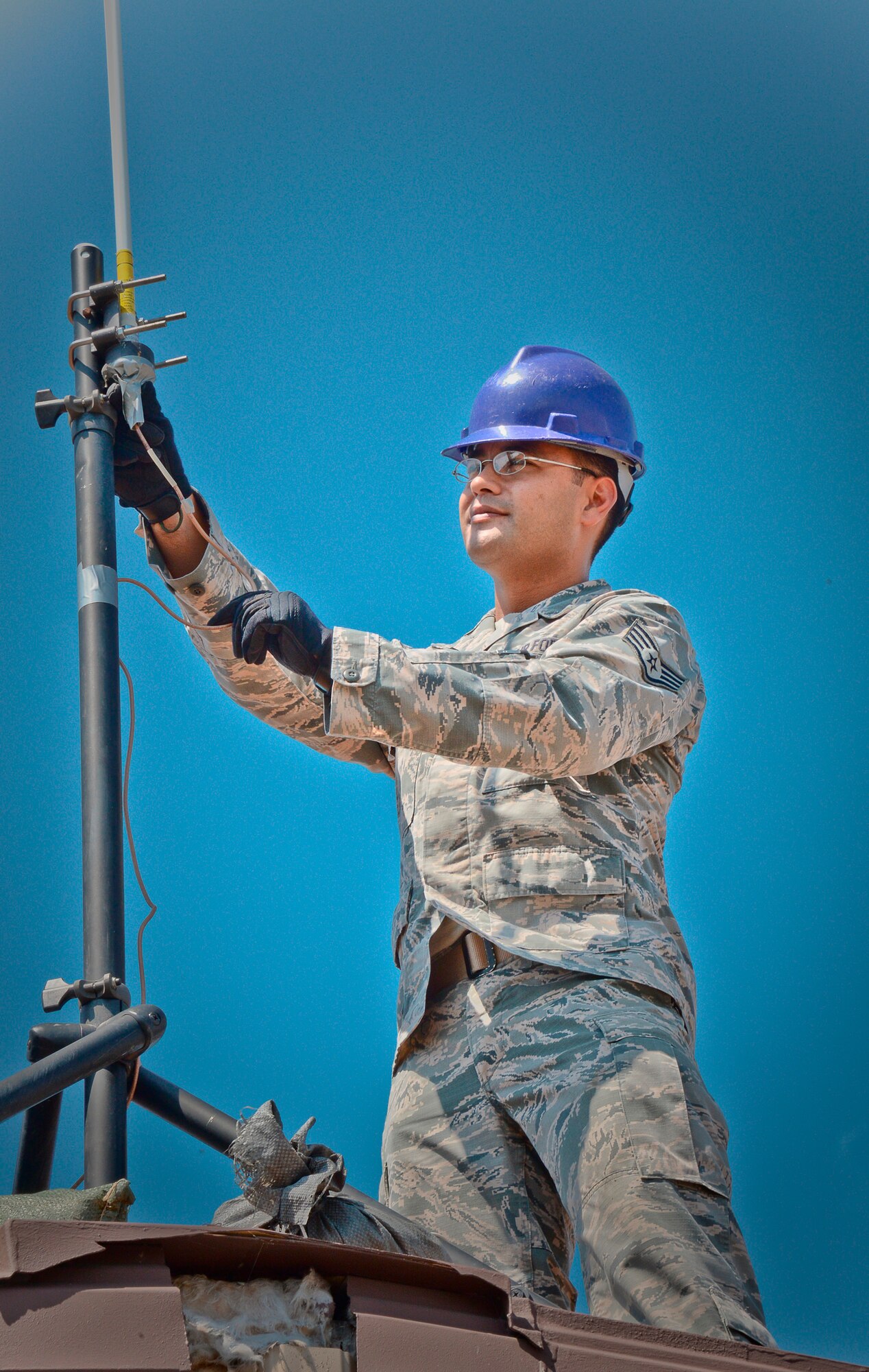 Staff Sgt. Roger Toliver, 644th Combat Communications Squadron radio frequency transmissions supervisor, performs a preventative-maintenance inspection on an antenna to ensure reliable radio communications are maintained Aug. 27, 2015 on Suwon Air Base, Republic of Korea. The 644th CBCS is in place at Suwon AB from Andersen Air Force Base, Guam, to help set up and maintain temporary communications to support and enable approximately 1,500 sorties during the displacement of Osan Air Base's assets and personnel. (U.S. Air Force photo/Tech. Sgt. Travis Edwards)