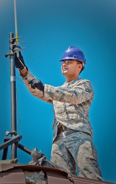 Staff Sgt. Roger Toliver, 644th Combat Communications Squadron radio frequency transmissions supervisor, performs a preventative-maintenance inspection on an antenna to ensure reliable radio communications are maintained Aug 27, 2015, at Suwon Air Base, Republic of Korea. The 644th CBCS is in place at Suwon AB from Andersen Air Force Base, Guam, to help set up and maintain temporary communications to support and enable approximately 1,500 sorties during the displacement of Osan Air Base's assets and personnel. (U.S. Air Force photo/Tech. Sgt. Travis Edwards)