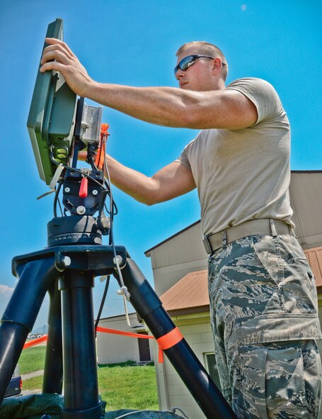 Airman 1st Class John Terkosi, 644th Combat Communications Squadron radio frequency transmissions apprentice, adjusts the angle of a radio frequency kit to improve communications link quality Aug 27, 2015, at Suwon Air Base, Republic of Korea. The RF-K is used to provide uninterrupted communication and ensures redundancies are in place in case a transmission link is lost. The 644th CBCS is in place at Suwon AB from Andersen Air Force Base, Guam, to help set up and maintain temporary communications. (U.S. Air Force photo/Tech. Sgt. Travis Edwards)