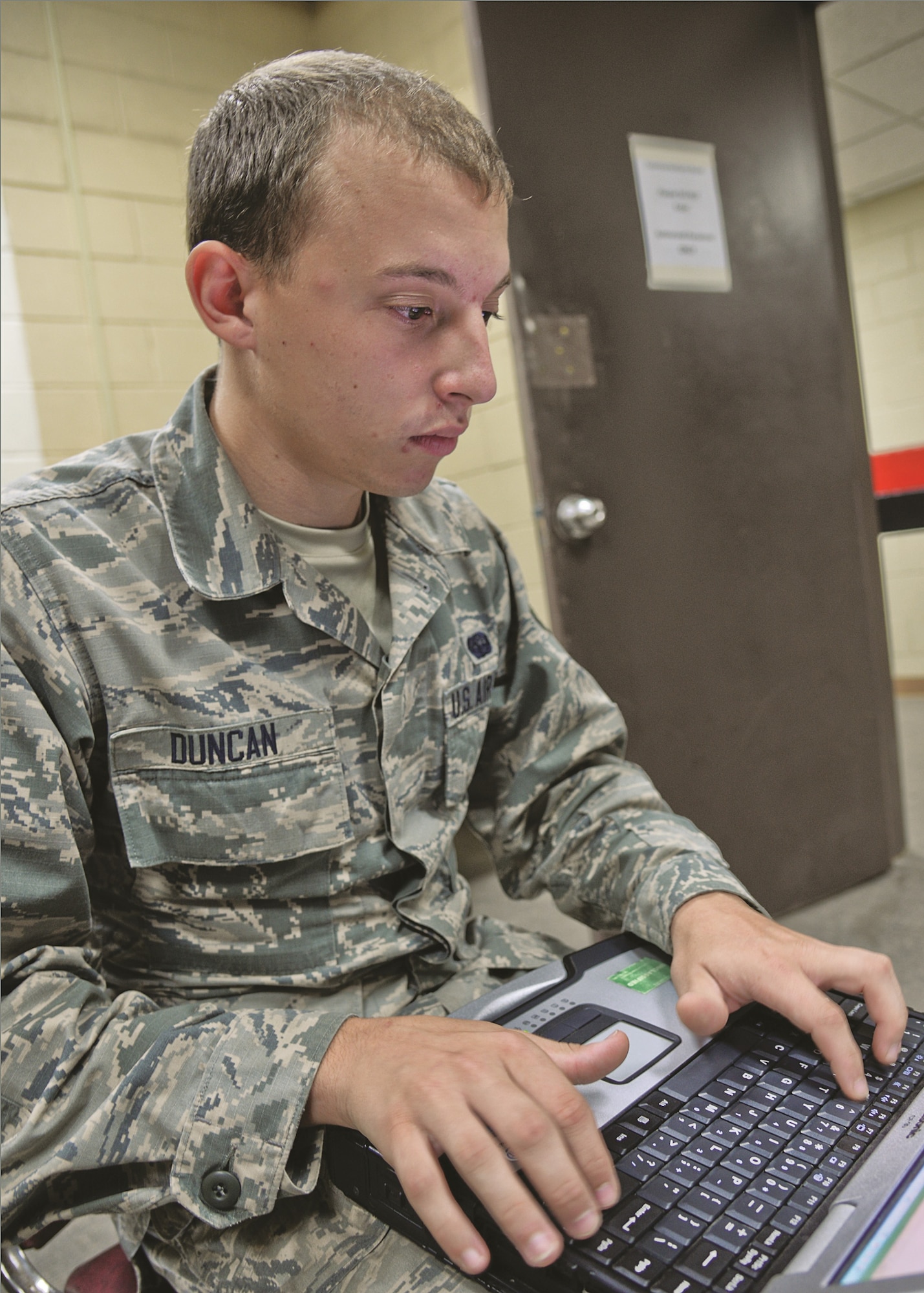 Airman 1st Class Lucas Duncan, 644th Combat Communications Squadron radio frequency transmissions apprentice, uses a laptop to monitor and control updates to wireless Air Force communications assets Aug 27, 2015 on Suwon Air Base, Republic of Korea. The 15-Airman team from the 644th CBCS is in place at Suwon AB from Andersen Air Force Base, Guam, to help set up and maintain temporary communications to connect approximately 200 devices and 700 displaced Osan Air Base Airmen. (U.S. Air Force photo/Tech. Sgt. Travis Edwards)