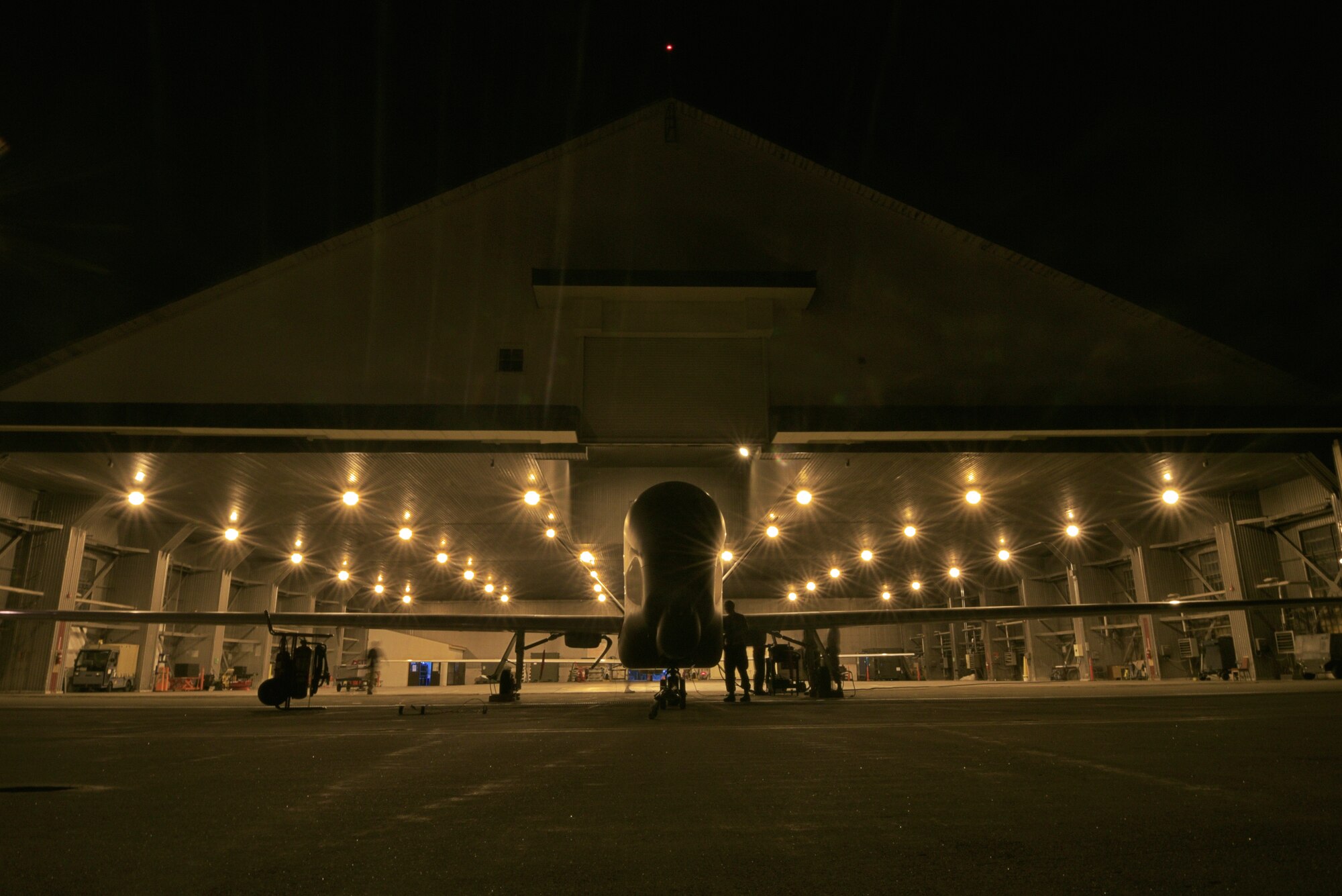 Maintainers from the 69th Maintenance Squadron perform an operations check on a RQ-4 Global Hawk at Misawa Air Base, Japan, Aug. 19, 2015. Before and after every RQ-4 flight, maintainers conduct an operations check and a 360-degree assessment of the unmanned aircraft to ensure there are no discrepancies. (U.S. Air Force photo by Senior Airman Jose L. Hernandez-Domitilo/Released)