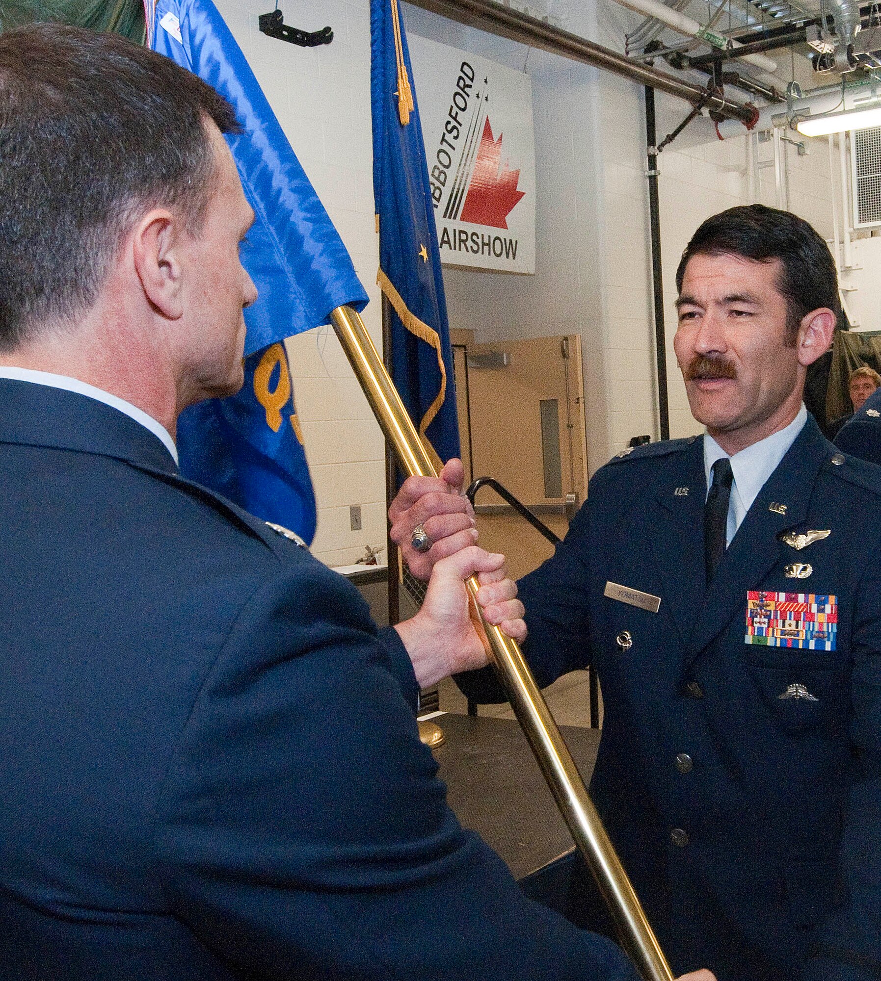 Lt. Col. Matthew Komatsu, a combat rescue officer with the Alaska Air National Guard's 212th Rescue Squadron, recieves his unit's command flag from Lt. Col. Tom Bolin, commander of the 176th Operations Group, in a ceremony on Joint Base Elmendorf-Richardson Aug. 27, 2015.  A veteran of multiple deployments, Komatsu had been serving as the squadron's director of operations. National Guard photo by Capt. John Callahan.