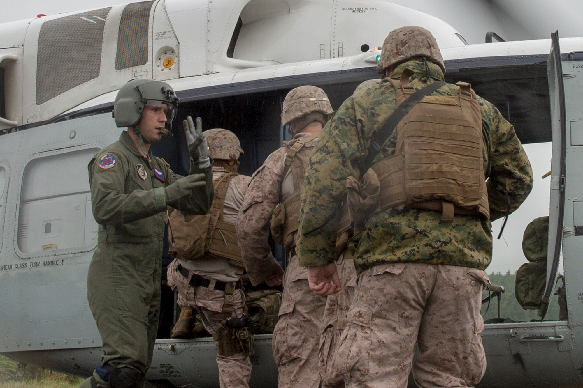 U.S. Air Force Staff Sgt. Nicholas Poe, 459th Airlift Squadron flight engineer, left, loads Combat Assault Battalion Marines with the 3rd Marine Division onto a UH-1N Iroquois during Exercise Iron Fist at Combined Arms Training Center Camp Fuji, Aug. 25, 2015. The UH-1N crewmembers participated in the joint exercise, providing an air asset for casualty evacuation and intelligence, surveillance and reconnaissance. The 459 AS regularly provides airlift capabilities in support of regional contingencies. (U.S. Air Force photo by Osakabe Yasuo/Released)
