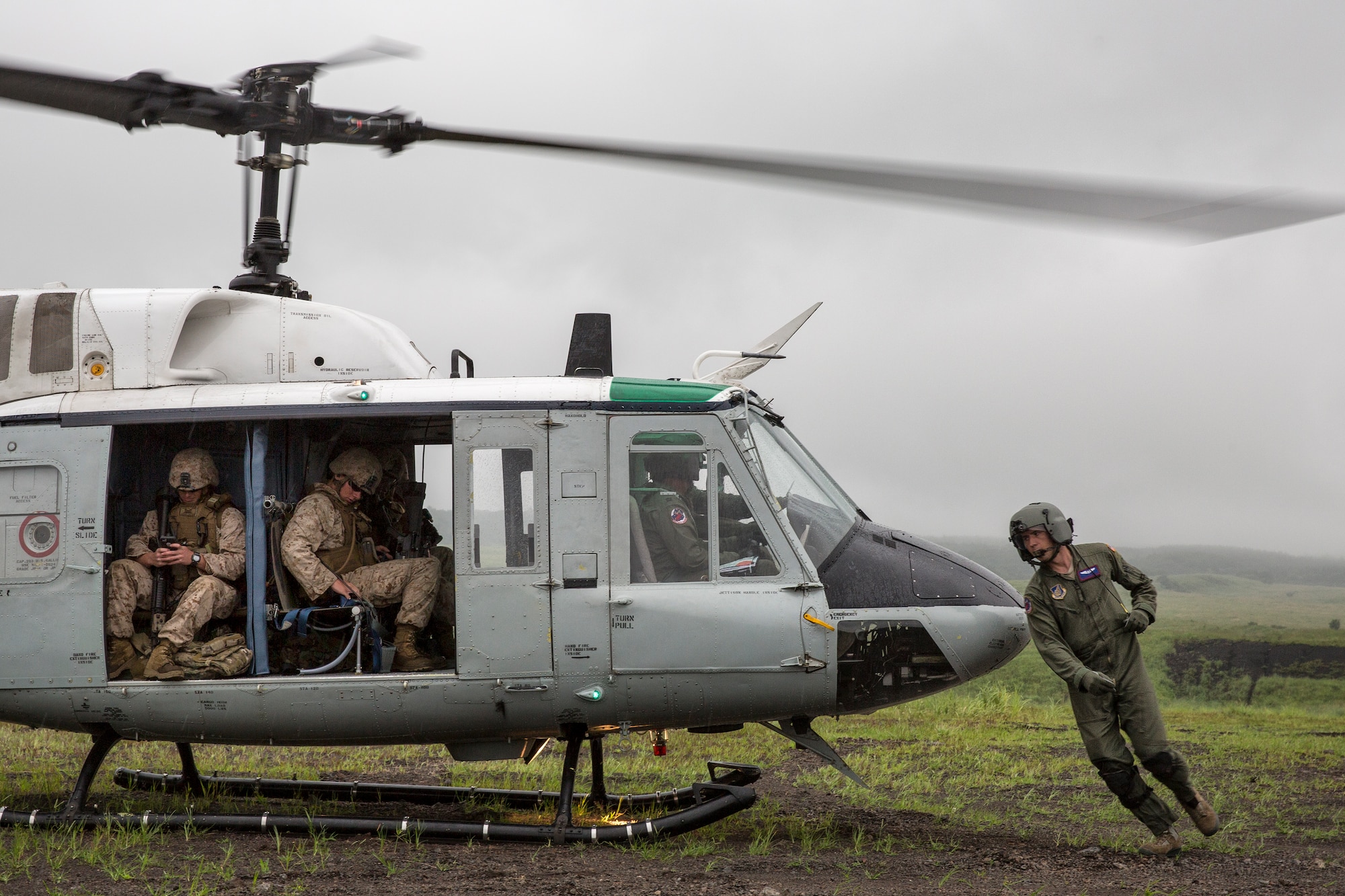 U.S. Air Force Staff Sgt. Nicholas Poe, 459th Airlift Squadron flight engineer, performs inspection of a UH-1 Iroquois after loading Combat Assault Battalion Marines with the 3rd Marine Division during Exercise Iron Fist at Combined Arms Training Center Camp Fuji, Aug. 25, 2015. The UH-1N crewmembers participated in the joint exercise, providing an air asset for casualty evacuation and intelligence, surveillance and reconnaissance. The 459 AS regularly provides airlift capabilities in support of regional contingencies. (U.S. Air Force photo by Osakabe Yasuo/Released)