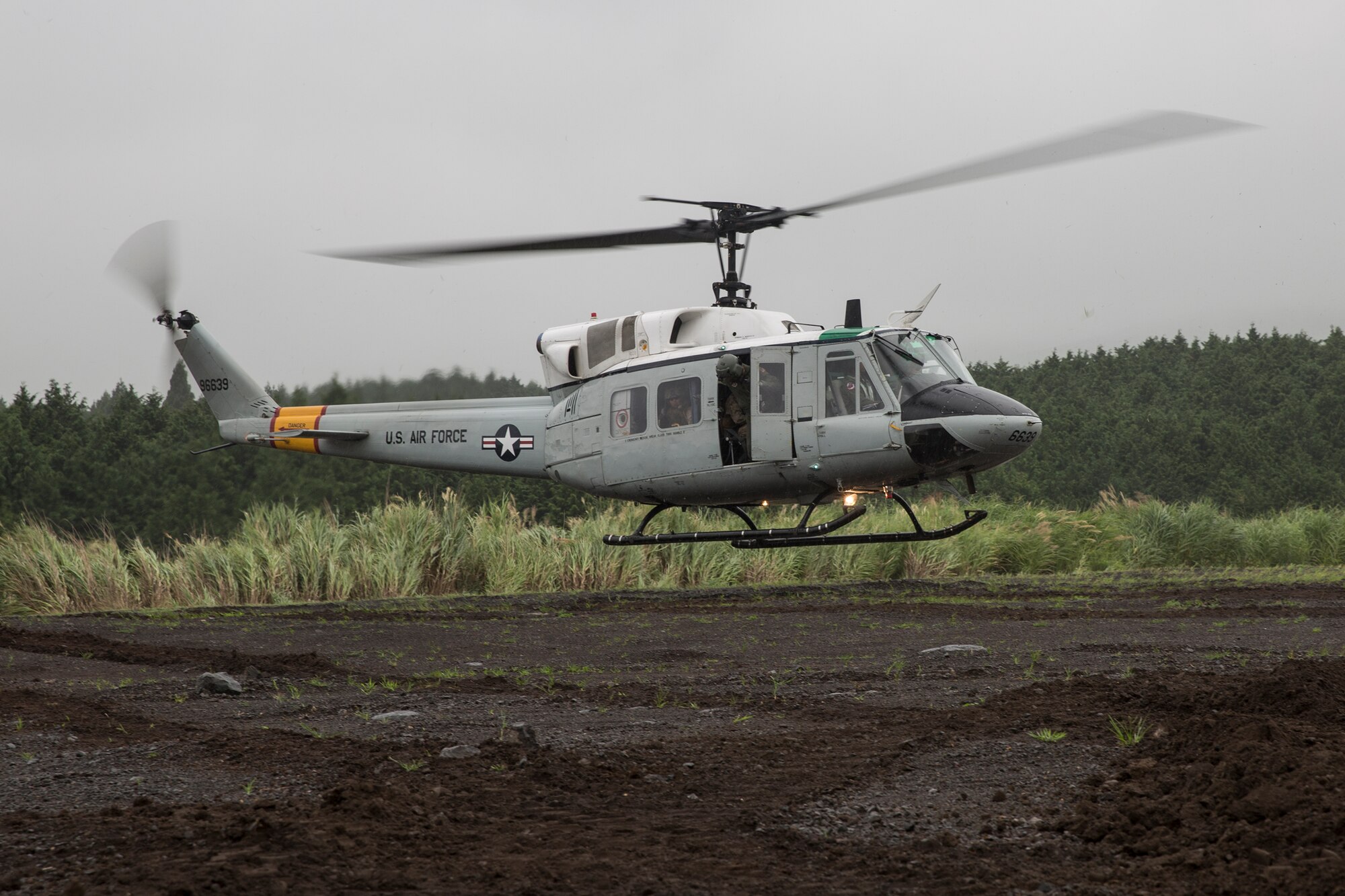 An UH-1N Iroquois with the 459th Airlift Squadron lands at Combined Arms Training Center Camp Fuji, Japan, during Exercise Iron Fist, Aug. 25, 2015. The UH-1N crewmembers participated in the joint exercise, providing an air asset for casualty evacuation and intelligence, surveillance and reconnaissance. The 459 AS regularly provides airlift capabilities in support of regional contingencies. (U.S. Air Force photo by Osakabe Yasuo/Released)