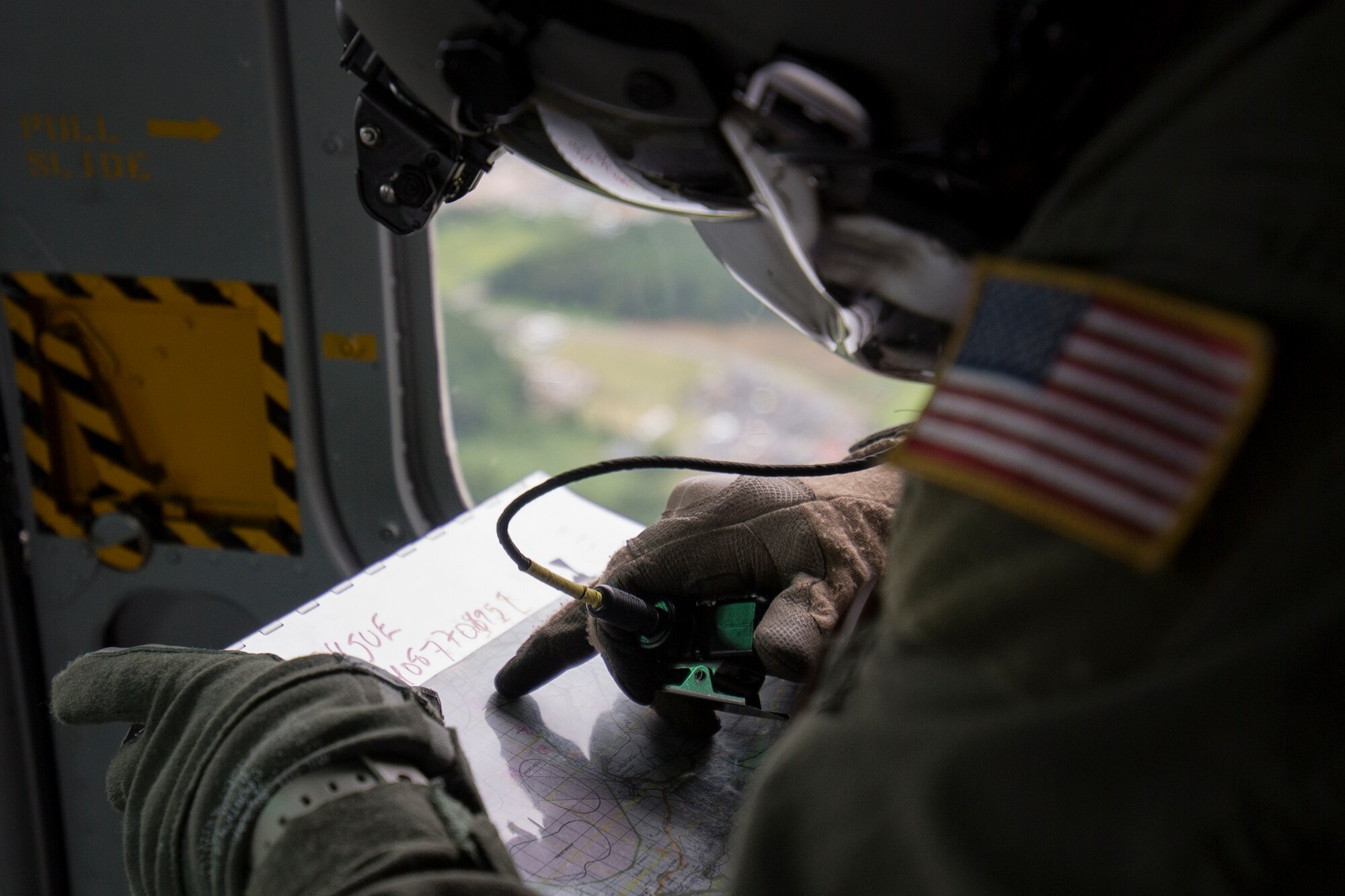 Staff Sgt. Christopher Rector, 459th Airlift Squadron flight engineer, checks a landing zone on the map during Exercise Iron Fist over Combined Arms Training Center Camp Fuji, Japan, Aug. 25, 2015. The UH-1N crewmembers participated in the joint exercise, providing an air asset for casualty evacuation and intelligence, surveillance and reconnaissance. The 459 AS regularly provides airlift capabilities in support of regional contingencies. (U.S. Air Force photo by Osakabe Yasuo/Released)