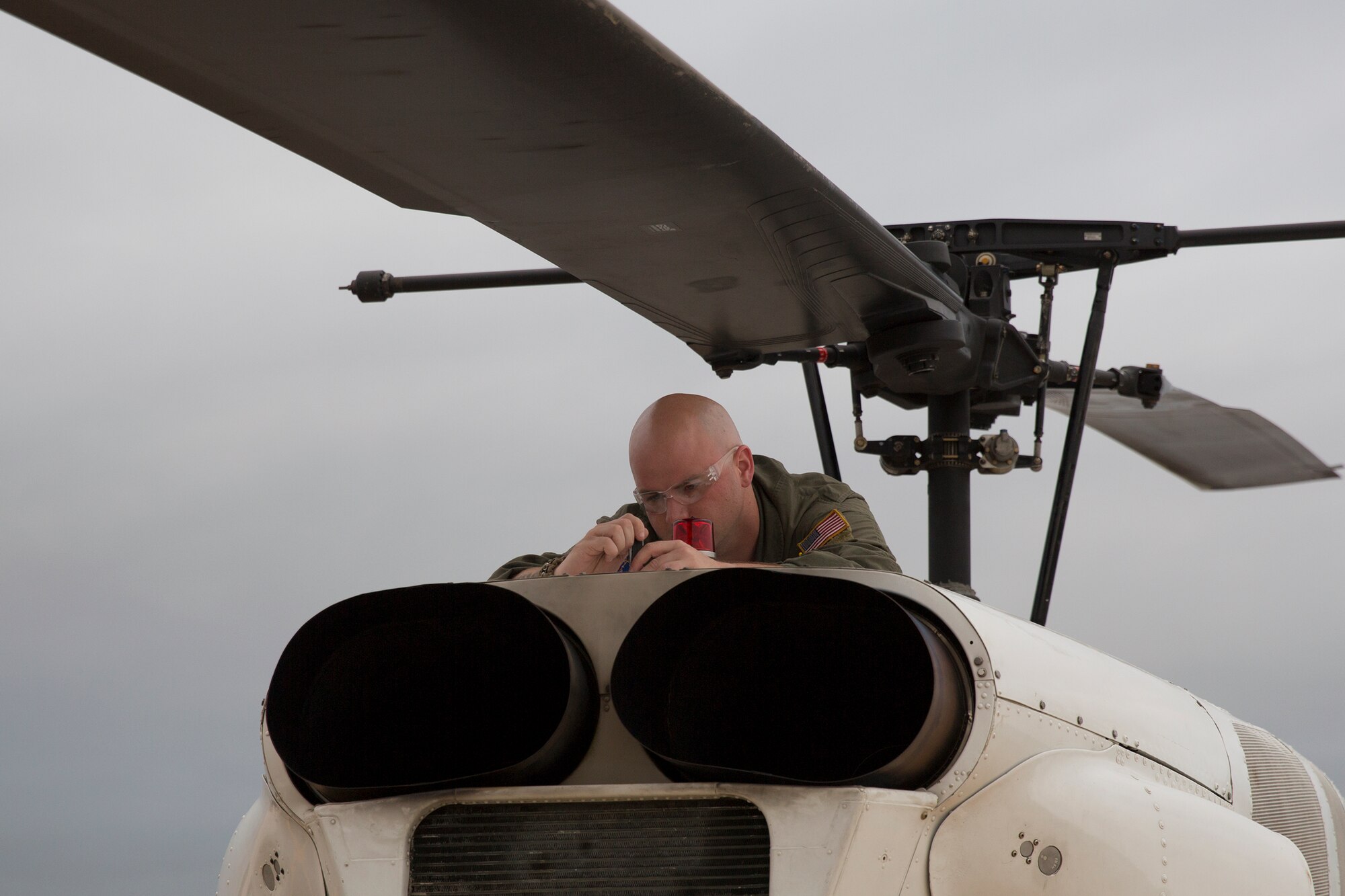 Staff Sgt. Christopher Rector, 459th Airlift Squadron flight engineer, performs pre-flight inspection on an UH-1N Iroquois at Yokota Air Base, Japan, Aug. 24. 2015. The UH-1N crewmembers participated in Exercise Iron Fist, providing an air asset for casualty evacuation and intelligence, surveillance and reconnaissance. The 459 AS regularly provides airlift capabilities in support of regional contingencies. (U.S. Air Force photo by Osakabe Yasuo/Released) 