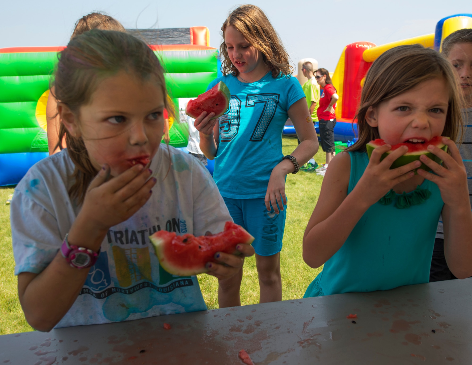 Hannah Bowman and Brooke Williford, both 8, compete in a watermelon eating contest during the annual Frontiercade event on F.E. Warren Air Force Base, Wyo., Aug. 21, 2015. Hannah is the daughter of Christina and Lt. Col. Joshua Bowman, 582nd Helicopter Group deputy commander, while Brooke is the daughter of Maria and Lt. Col. Rusty Williford, 320th Missile Squadron commander. Frontiercade is meant to give F.E. Warren Airmen and their families a day of games, sports and free food before the start of the new school year. (U.S. Air Force photos by R.J. Oriez/Released)