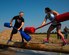 Landon Strand, 90th Medical Group, and Alexandra Ayub, 90th Force Support Squadron, face off with pugil sticks over muddy water on F.E. Warren Air Force Base, Wyo., as they take part in a jousting competition Aug. 21, 2015. The two were taking part in Frontiercade, which is meant to give F.E. Warren Airmen and their families a day of games, sports and free food before the start of the new school year. (U.S. Air Force photos by R.J. Oriez) 
