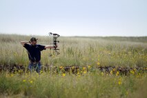 Victor Gardner, 3rd Space Operations Squadron, aims his bow as he competes in the Force Support Squadron’s annual archery competition at the archery range on Schriever Air Force Base, Colorado, Friday, Aug. 21, 2015. Seth Cannello took 1st place with 6 placement points. Andrew Rowland and Victor Gardner rounded out the top three with 8 and 9 placement points respectively. (U.S. Air Force photo/Katie Calvert)