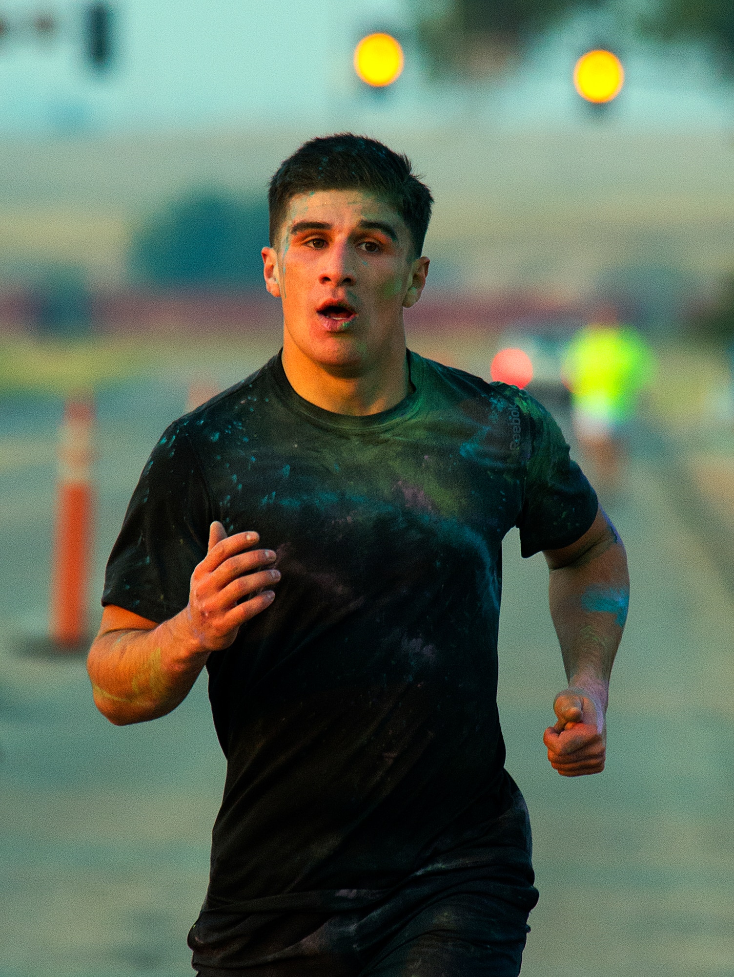 Christian Acosta represents the 90th Force Support Squadron in the early-morning five-kilometer color run on F.E. Warren Air Force Base, Wyo., Aug. 21, 2015. The early-morning run marks the start of Frontiercade, an annual day of competition, games and free food, for 90th Missile Wing Airmen and their families, before the start of the school year. (U.S. Air Force photos by R.J. Oriez/Released)