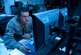 Senior Airman Zachary Pirrung, 90th MW Command Post senior emergency action controller, mans the command post at 12:54 a.m., Aug. 25, 2015. Pirrung was one half of the two-person team making up the night shift. A minimum of two individuals are required to always be available in the office 24/7, 365 days a year. (U.S. Air Force photo by Airman 1st Class Malcolm Mayfield)