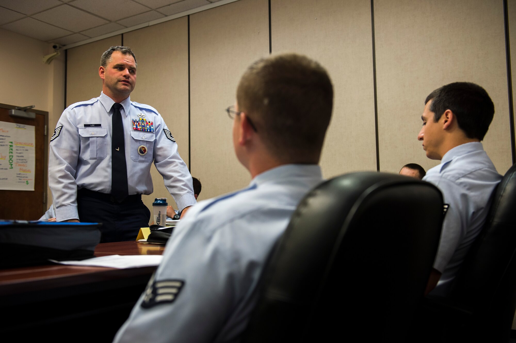 Tech. Sgt. James Lee, 62nd Airlift Wing Professional Military Education instructor, speaks with students about the results of their graded assignment Aug. 26, 2015, at the Julius A. Kolb Airman Leadership School at Joint Base Lewis-McChord, Wash. Lee has been a PME instructor at the school for 2 1/2 years. (U.S. Air Force photo/Tech. Sgt. Sean Tobin)