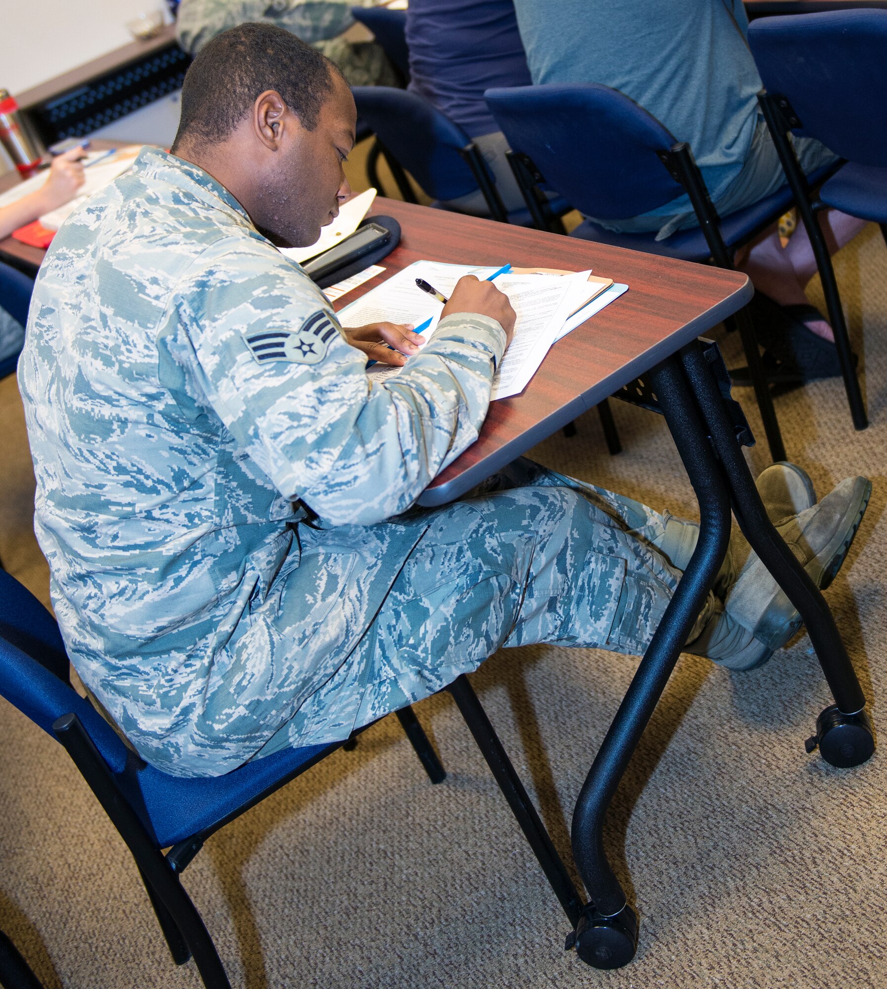 U.S. Air Force Senior Airman Rashawn Franklin, 822nd Base Defense Squadron fire team member, fills out an out-processing checklist at a Group Pre-separation Counseling briefing Aug. 25, 2015, at Moody Air Force Base, Ga. During the briefing, 23d Force Support Squadron personnel distributed pamphlets and brochures on how to search and utilize employment and relocation assistance, healthcare options, veteran benefits and how to further their education. (U.S. Air Force photo by Airman 1st Class Greg Nash/Released)