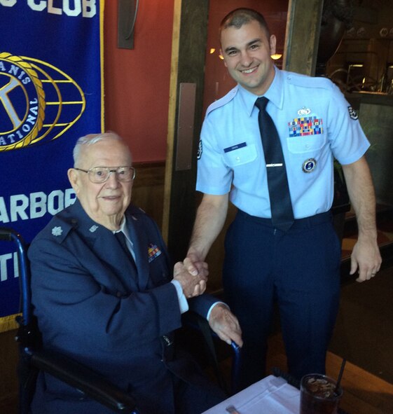 Staff Sgt. Lee Davis, 339th Recruiting Squadron, congratulates retired Air Force Lt. Col. Russell Woinowsk at his 100th birthday party in Ann Arbor, Michigan, Aug. 11, 2015. Woinowsk served as a bombardier in World War II and then as a bombardier trainer during the Korean War. (U.S. Air Force photo)
